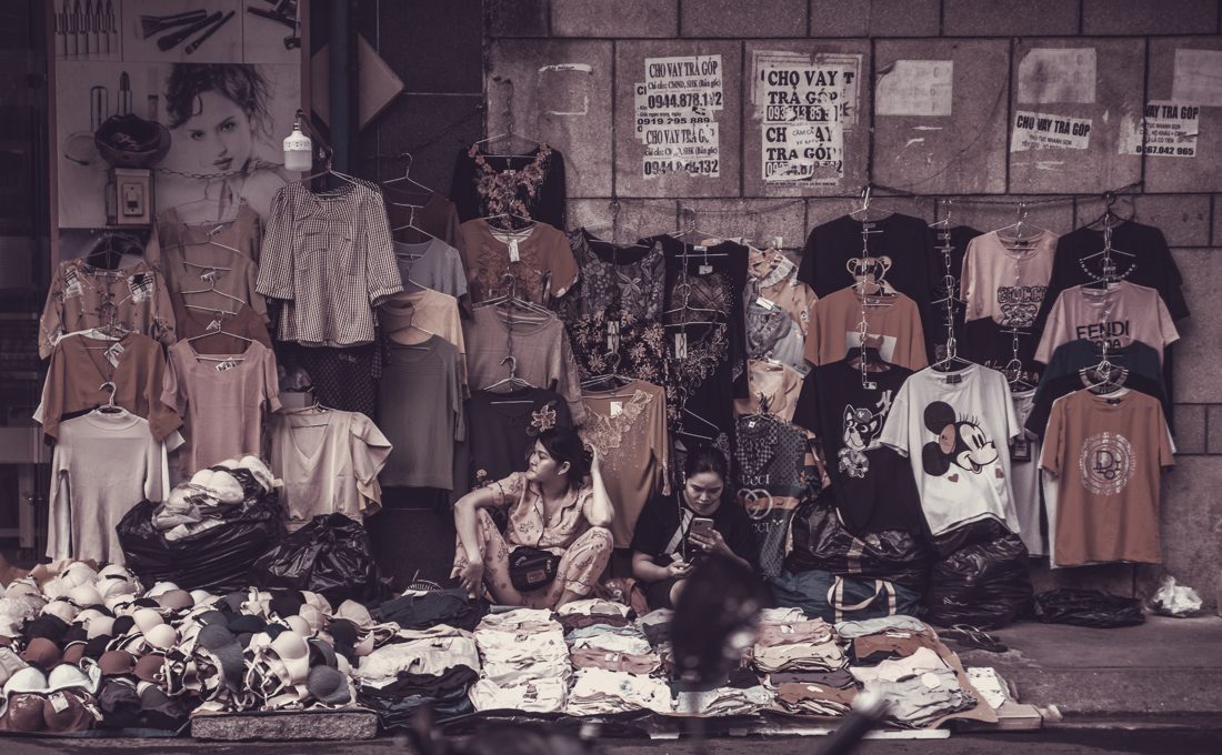 Street market stall with T-shirts, jeans and jackets — a resale level our lots supply