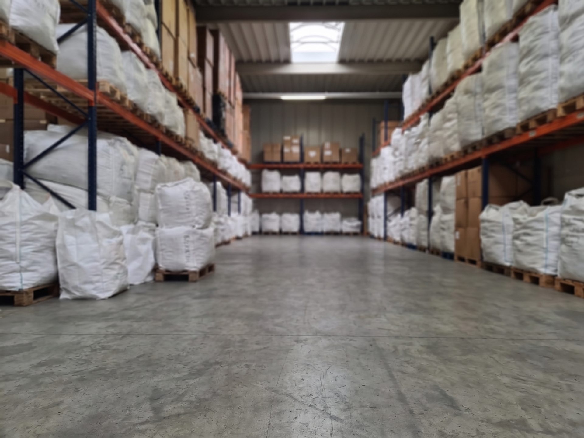 Storage racks in our warehouse in Neuss with pallets of packed fashion lots
